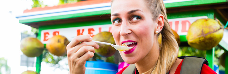 Tourist Eating From A Street Stall In Bali