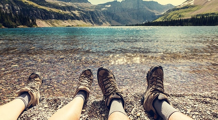 Travellers sitting by a lake 