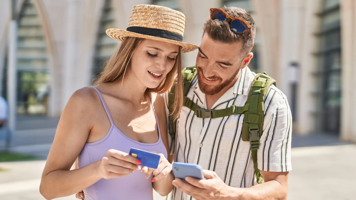 tourists on holiday holding a credit card
