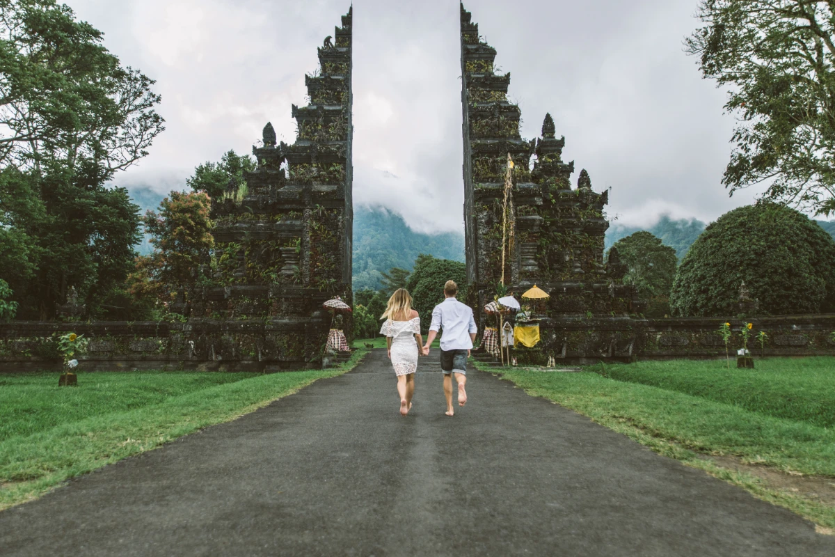 a couple visiting a temple in bali